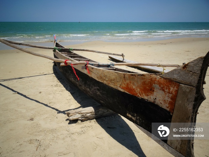 The small wooden boat on a sandy beach (Morondava, Madagascar)