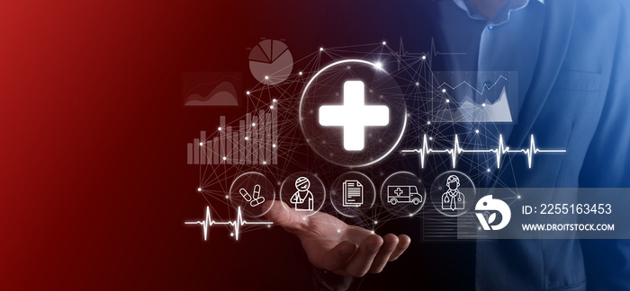 Businessman hold virtual plus medical network connection icons. Covid-19 pandemic develop people awareness and spread attention on their healthcare.Doctor,document,medicine,ambulance,patient icon.