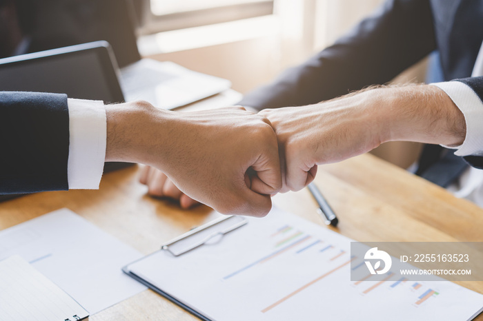 Congrats, business partnership people, two asian and caucasian young man fist bumping, shaking hands together with partnership, customer or colleague after work is done, successful. Worker meeting.