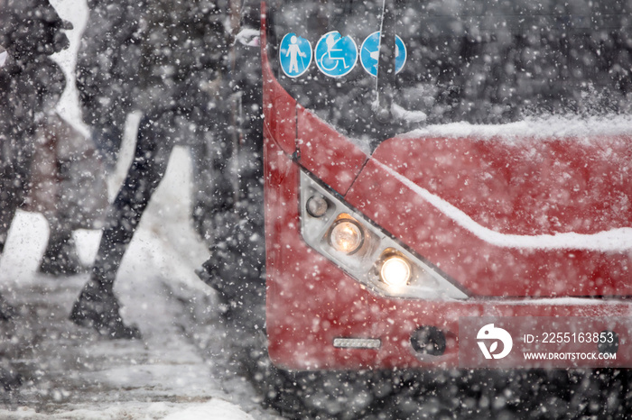 Bus public transportation on snowy streets in winter conditions.