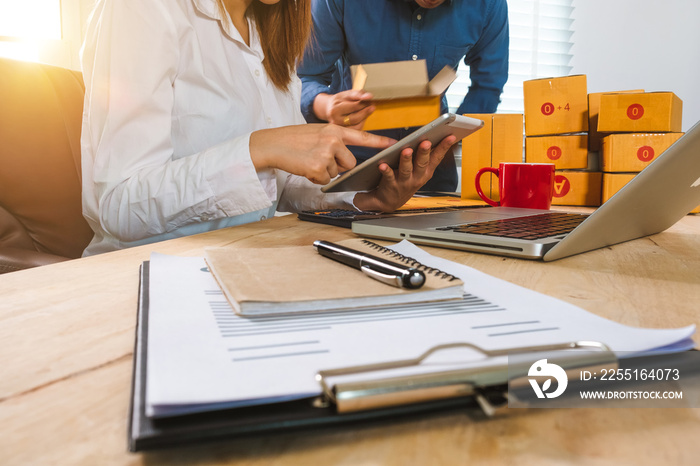 young Asian man and woman at office of their business online shopping.In home office