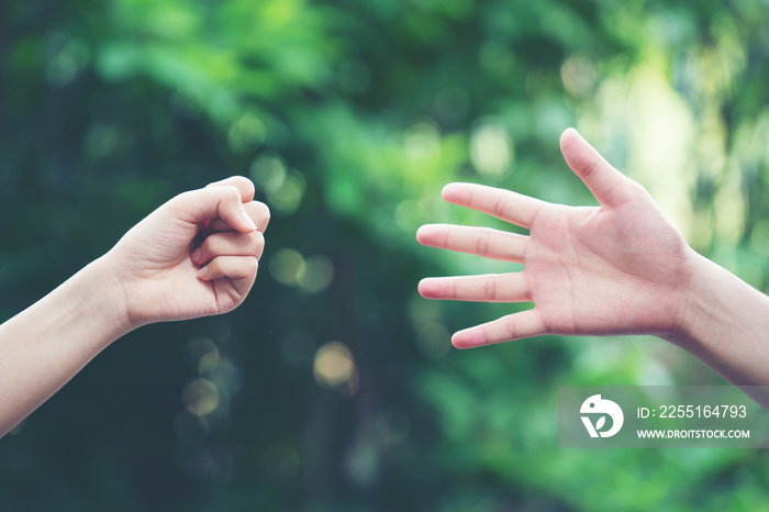 Couple play rock paper scissors hand game