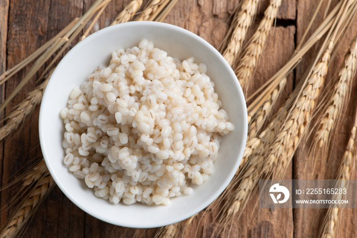 Cooked peeled barley grains in white bowl