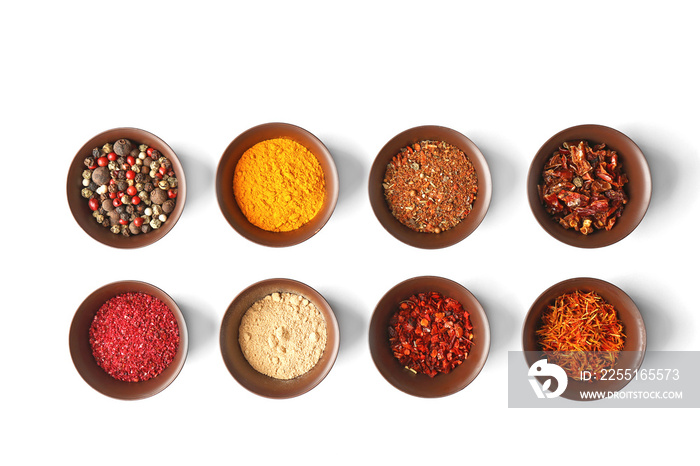 Flat lay of assorted herbs and spices on white background