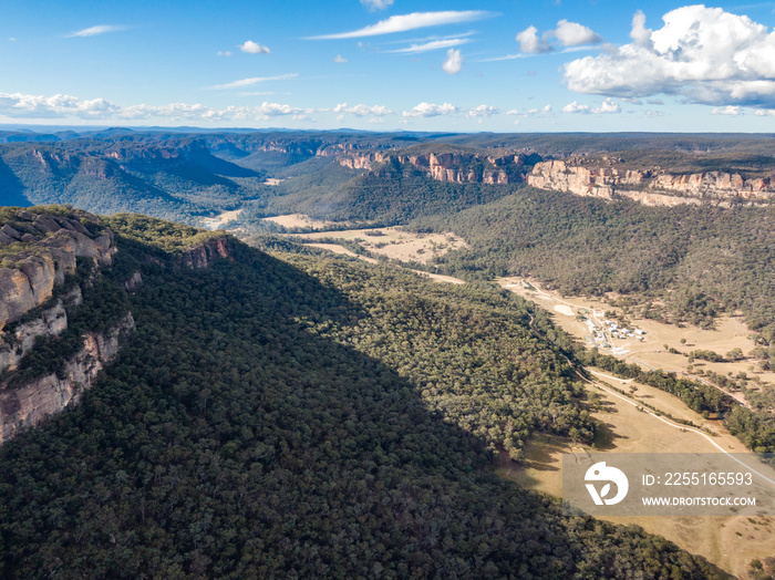 Aerial panoramic drone view of Wolgan Valley along the Wolgan River in the Lithgow Region of New South Wales, Australia. Part of the Blue Mountains near Sydney.