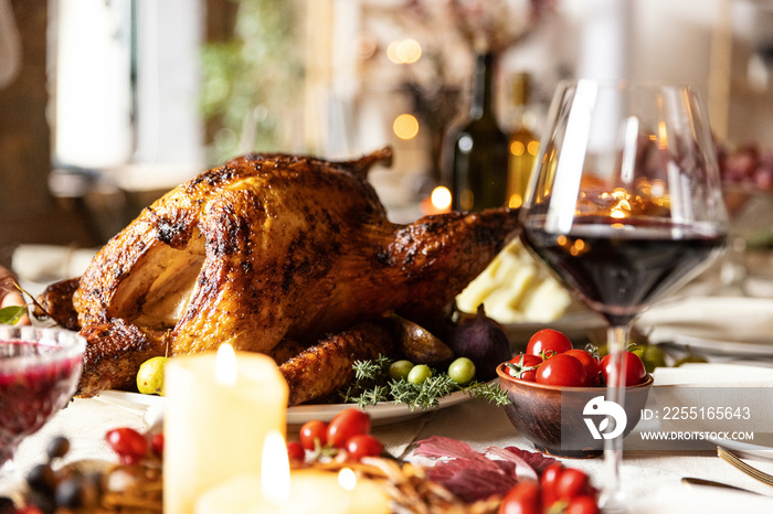 Close-up festive decorated table with roasted turkey and holiday traditional food, dishes. Happy Thanksgiving day