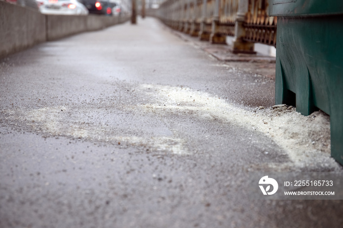 Salt spilled on the pavement. abstract seasons background.