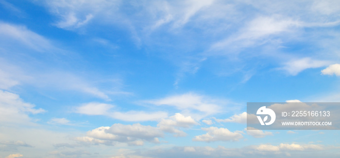 Cumulus clouds in the blue sky. Wide photo.