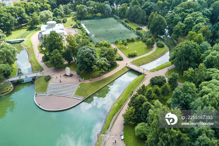 Top view of a park with a river and a football field