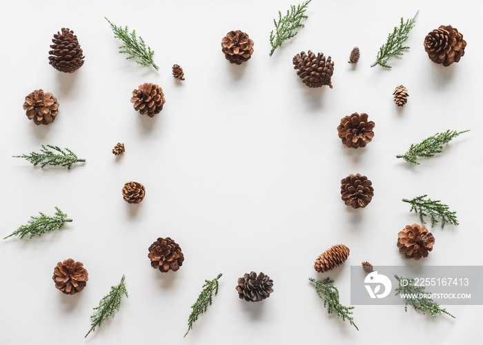 Christmas background, frame with fir branches tree pinecone over white background. flatlay copy space