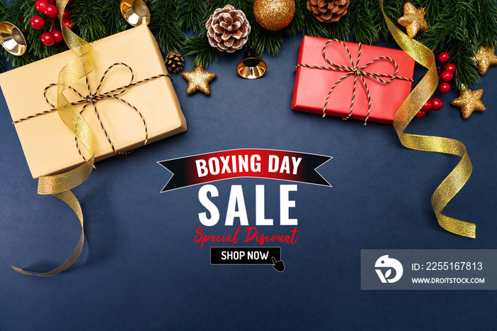 Boxing day sale with Christmas present and xmas decoration on blue background