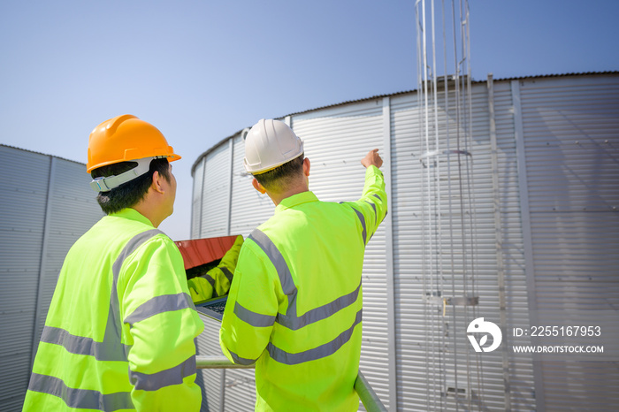 Two Asian male industrial engineers Work is planning work inspection work in the engineering industry. utilities Sewers and central wastewater treatment plants