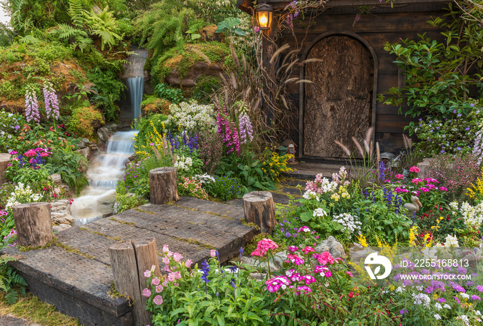 Landscaped backyard of old house with flower garden