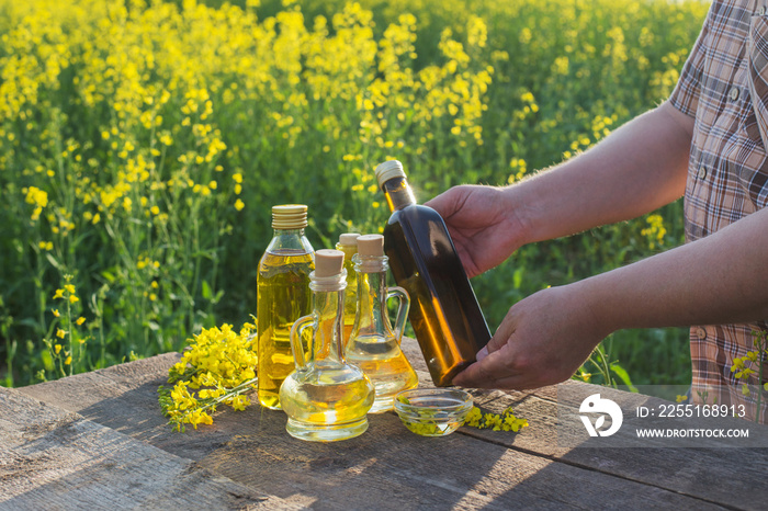 rapeseed oil on wooden table in field