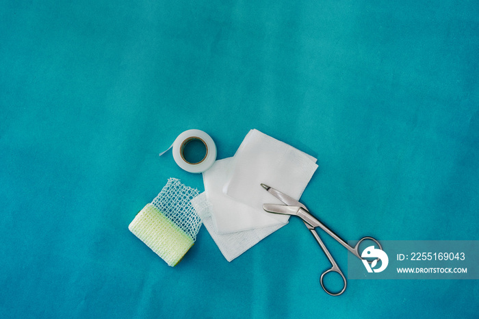 plaster ,net bandage ,gauzes and scissors for dressing clean wound on medical background with copy space ,flat lay