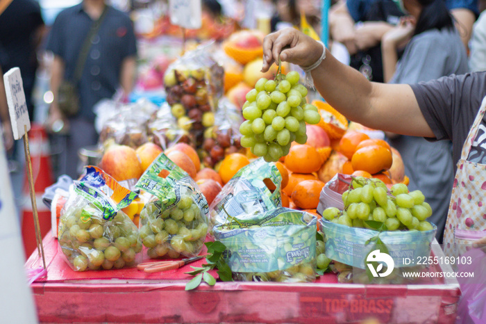 Buying and selling Fruit at Street food in Chinatown Bangkok Thailand and people high concentration of them in busy areas this is Landmark of Street food of Bangkok