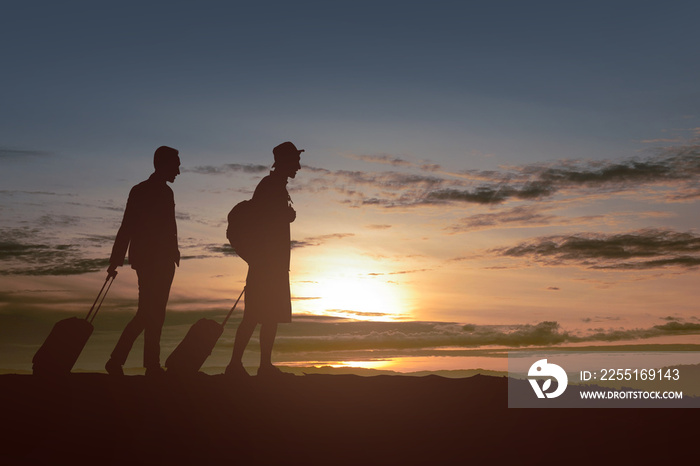 Silhouette of two-man with backpack and suitcase standing in the morning