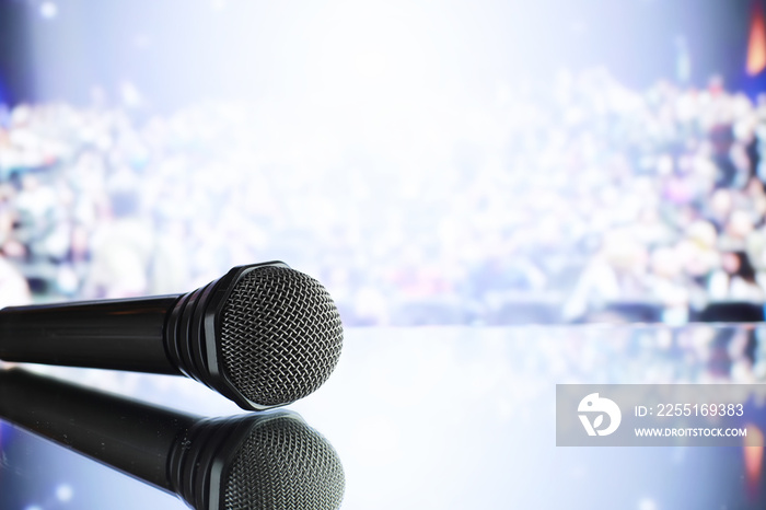 The microphone on the stage in front of the hall. Performance on stage.