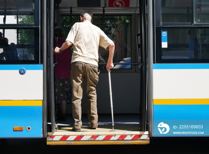 Old man is getting on the bus