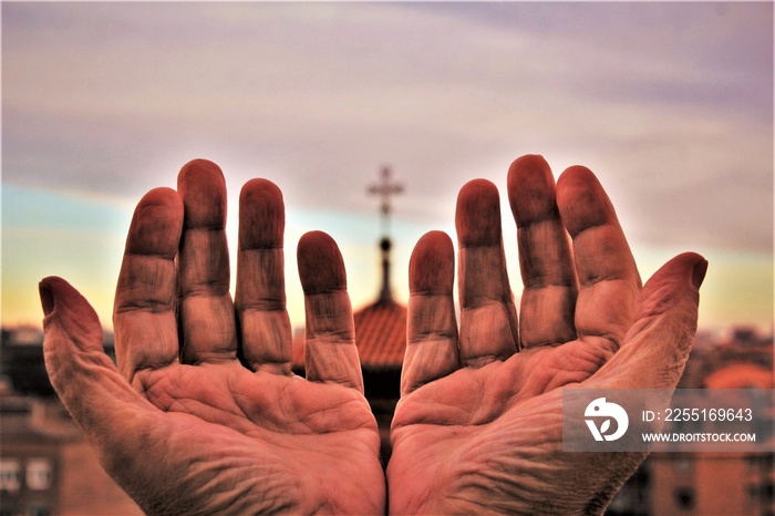 Praying hand cross of Church between hands. photo