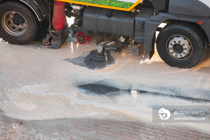 Municipal teams cleaning the streets after the flood - Municipal cleaning vehicle cleans the streets