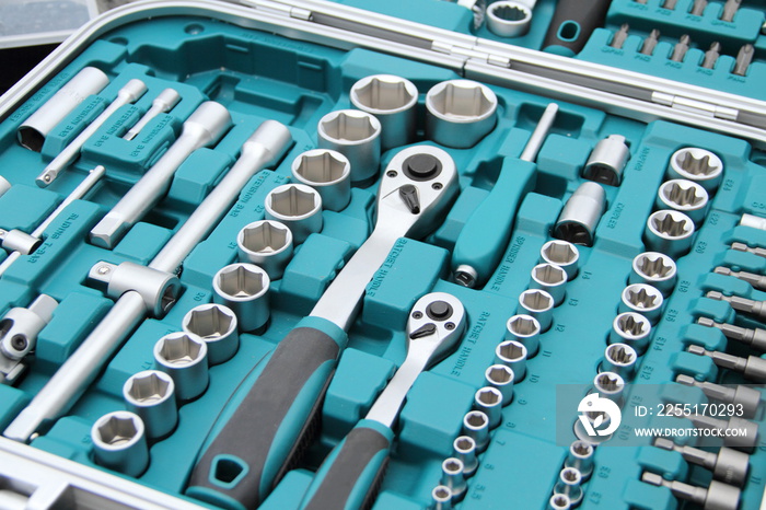 a fully stocked ratchet box with various bits and nuts