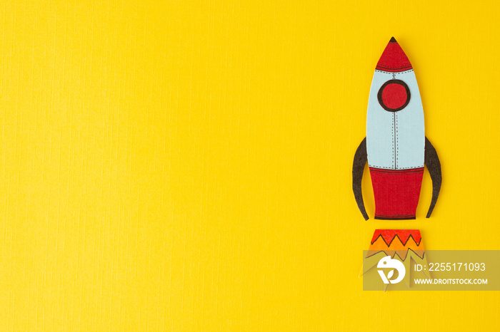 Start up business concept. Boost or increase incomes, salary. Drawn rocket on colorful yellow background. Copy space.