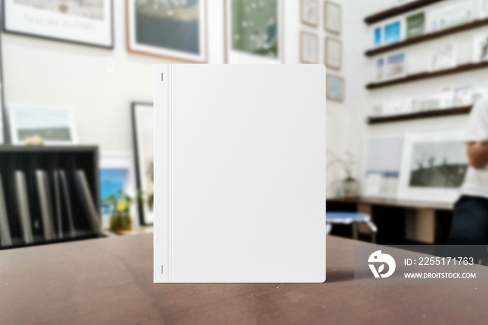 Clean minimal photo book 5x7 mockup standing on top table with leaves