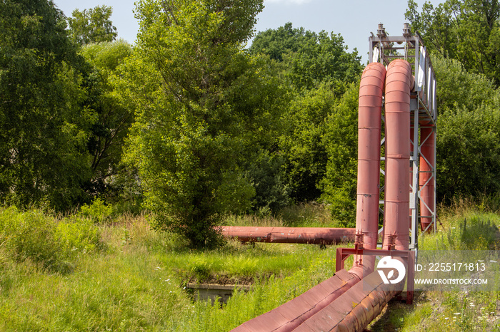 Hot water - steam pipes with bridging in summer nature