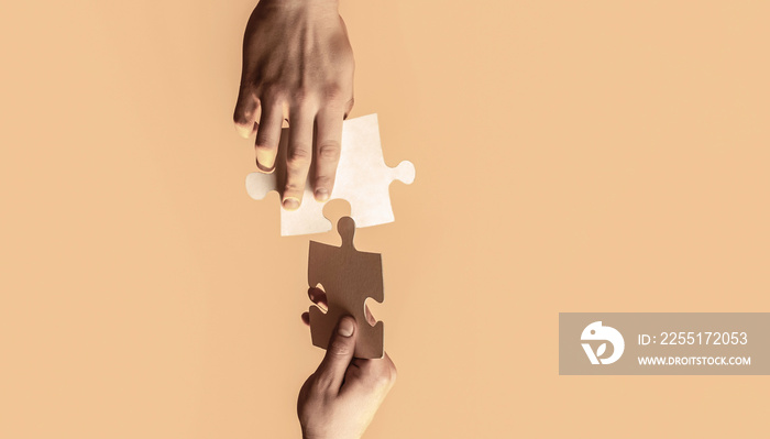 Closeup hands of man connecting jigsaw puzzle. Business solutions, success and strategy concept