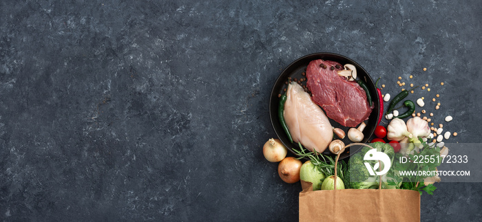 Paper bag vegetables, fruit and meat on dark background with copy space top view. Bag food concept