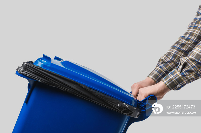 partial view of cleaner with trash bin isolated on grey