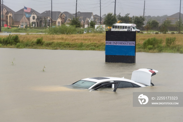 Sedan car swamped by flood water in Humble, Texas, US by Harvey Tropical Storm. Flooded car under deep on heavy high water road. Disaster Motor Vehicle Insurance Claim Themed. Severe weather concept