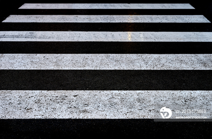 view of a black and white crosswalk in the rain