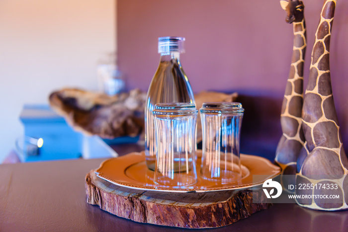 Glasses and a bottle of water in an African game lodge, Namibia