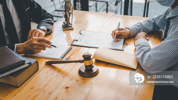 Close-up of a judge with a hammer against the background of professional lawyer talking about a lawsuit. professional lawyers discussing legal case.