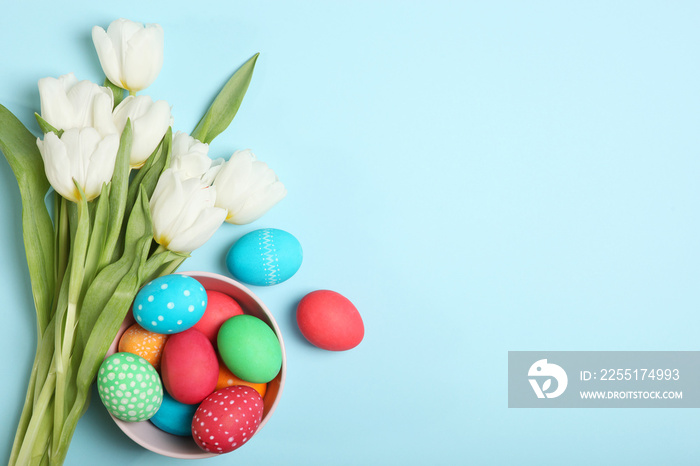 Easter eggs and flowers on the table top view. Easter composition with a place to insert text.