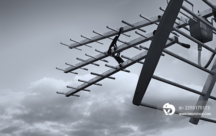 Television aerial against a cloudy sky in Black and White