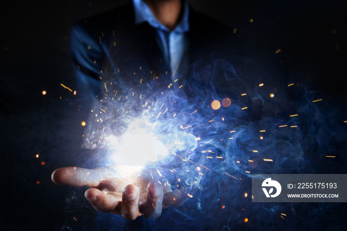 businessman holds fire in his hands.