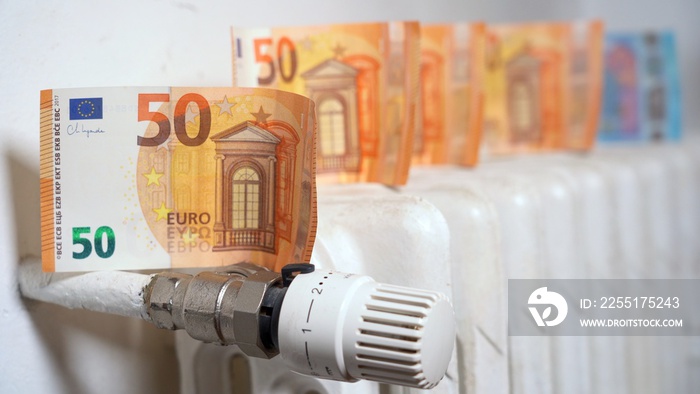 Europe, Italy , Increase in the cost of bill for  gas and electricity causes increased price for the procurement of raw materials, money euro banknote and domestic heating radiator