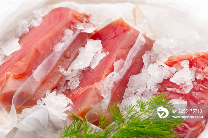 Frozen Tuna steak vacuum with ice on the counter the fishmarket. healfy food and nutrition concept