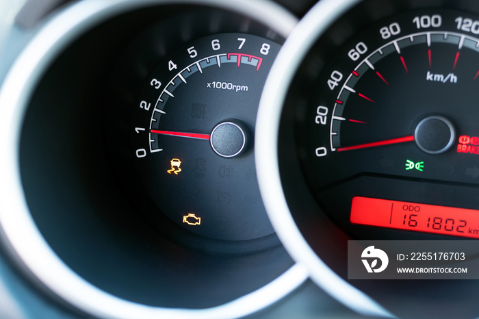 Engine check orange light show on car dashboard. The car need servicing due to engine problem.