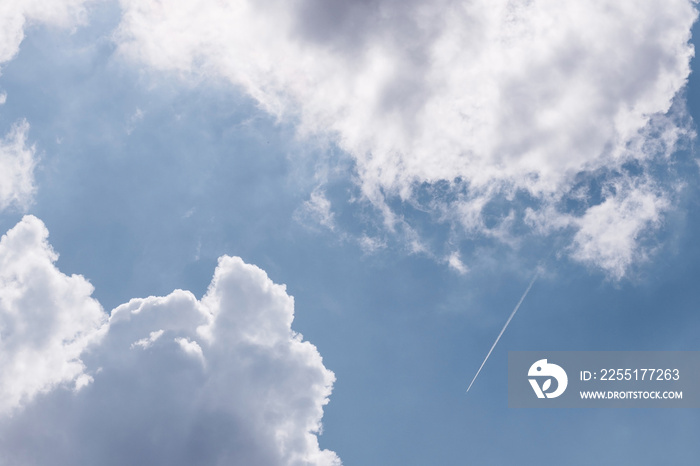 Airplane trails seen between clouds