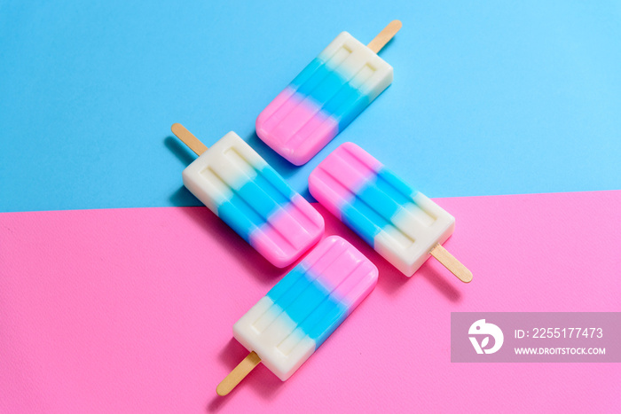 Fruit Ice cream stick , popsicle , ice pop or freezer pop with copyspace on blue and pink pastel background or texture