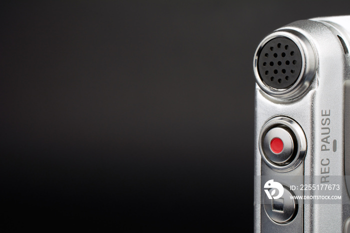 dictaphone closeup of a red record button selective focus dark blurred background wiretapping concept copy space