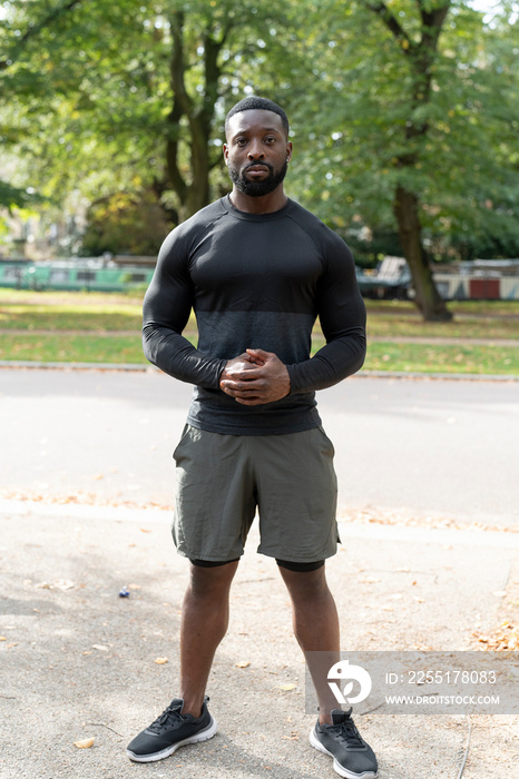 Portrait of athletic man standing in park