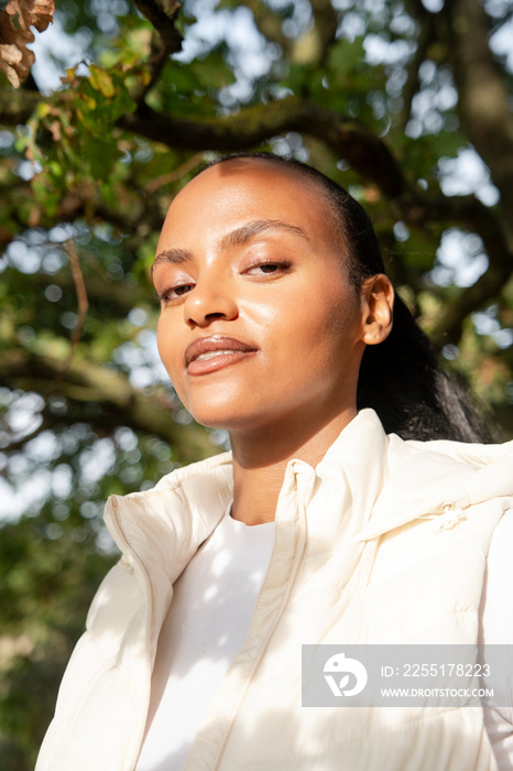 Portrait of smiling woman in sunlight outdoors