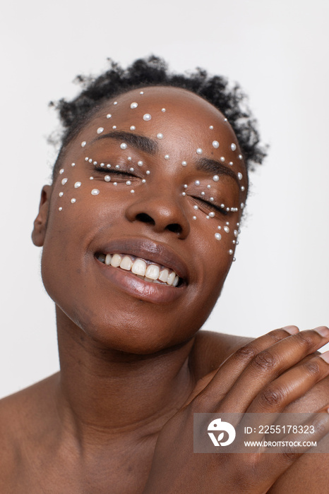 Smiling young woman wearing pearl freckles