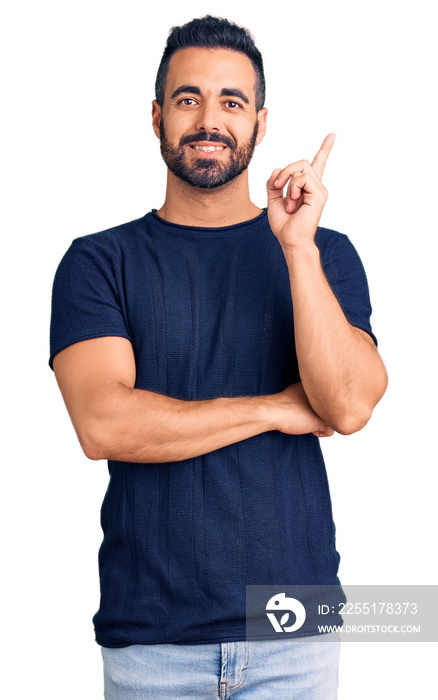 Young hispanic man wearing casual clothes smiling happy pointing with hand and finger to the side