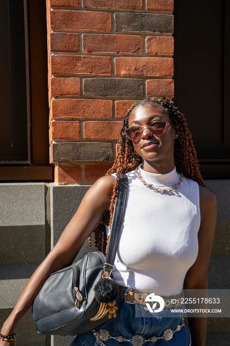 Portrait of woman wearing sunglasses and white top